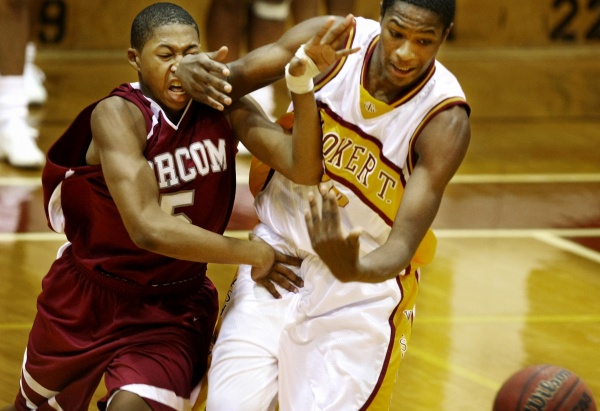  fights for a loose ball against Booker T. Washington's Quintin Upshur in 