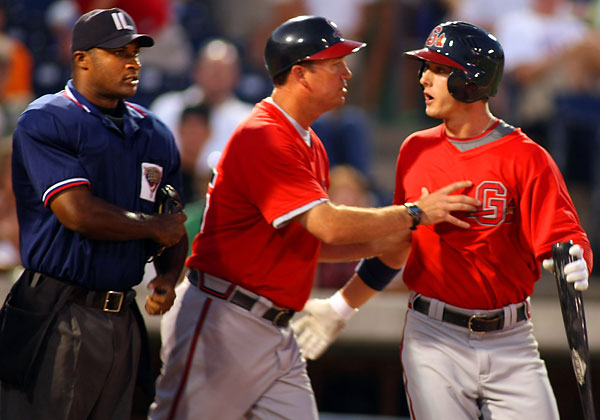 Gwinnett's Jordan Schafer right is restrained by manager Dave Brundage 
