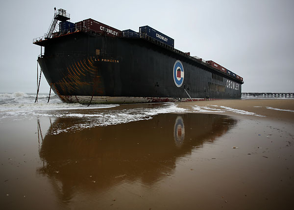 On Saturday, Nov. 14, 2009, the massive barge along Sandbridge Beach in Virginia Beach was still aground. The barge, located about 75 yards from a pier, didn't move overnight. (Ross Taylor | The Virginian-Pilot



