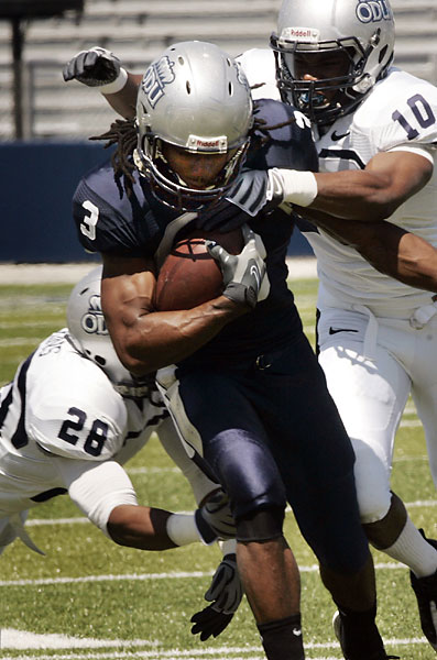 ODU's wide receiver, Marquel Thomas, manages to break a couple of tackles to pick up some ground during the Monarchs spring football scrimmage. Norfolk April 10, 2010. (David B. Hollingsworth | The Virginian-Pilot)