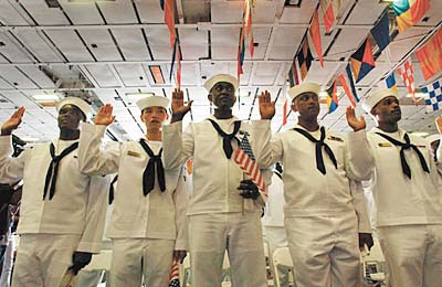 Sailors taking an oath of allegiance on the carrier Roosevelt on Friday included 
Carlisle Pennycooke from Jamaica, Nai Li from China, Christopher Ezomo from Nigeria, Henol
Getachew from Ethiopia, and Johan Peguero from the Dominican Republic. 
<p> 