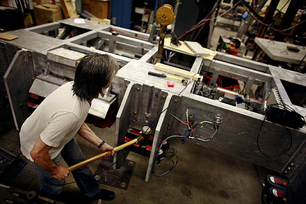 Engineering professor Thomas Alberts, who has taken charge of the maglev research, taps the magnets on the model being analyzed at ODU. The system is becoming more stable, Alberts said.  
 
 
