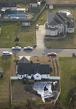 Plastic covers a swimming pool excavation site on Wednesday where contractors Tuesday uncovered 20 large barrels of unknown chemicals. The house is in Wingfield Pointe in Chesapeake. 
 
 
 
 
 
 
 
