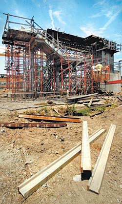 Workers take apart scaffolding around a partially built maglev train station near Hampton Boulevard at Old Dominion University.
 
 
 
