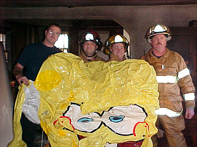 Chesapeake firefighters, from left, Robert Stewart, Maury Brickhouse, Matt Bunting and David Elliott display an inflatable version of the cartoon character SpongeBob that was  found in a burning South Norfolk home.