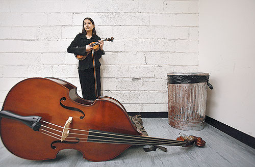 Livia Amoruso, 14, who brought a violin and a bass that's bigger than she is