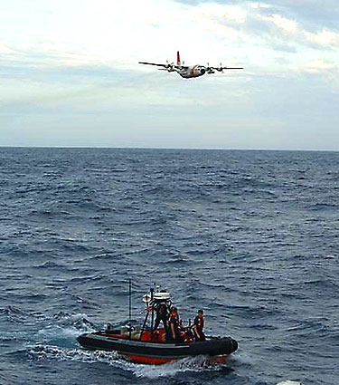 A C-130 airplane and a Coast Guard boat search for survivors of the sailing yacht Flying Colours.  
