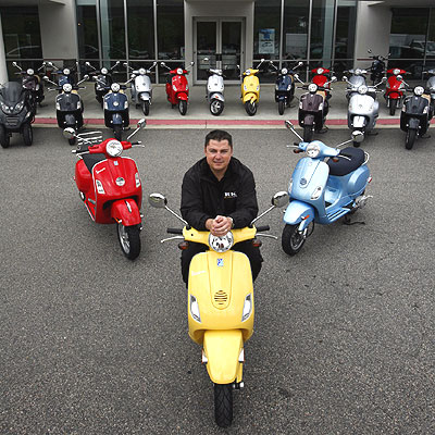  at RK Auto Group in Virginia Beach sits on a readytogo yellow Vespa