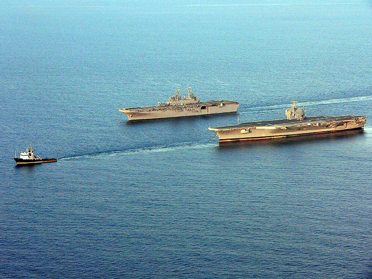 The amphibious assault ship Kearsarge pulls alongside the aircraft carrier John F. Kennedy in the Atlantic Ocean on July 30, 2007 as it was being towed to Norfolk after being decommissioned in Mayport, Fla. (U.S. Navy)